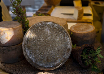 heads of cheese at a farmer's market