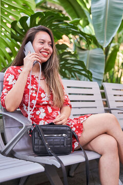 Young Latina Woman Talking On The Smart Phone