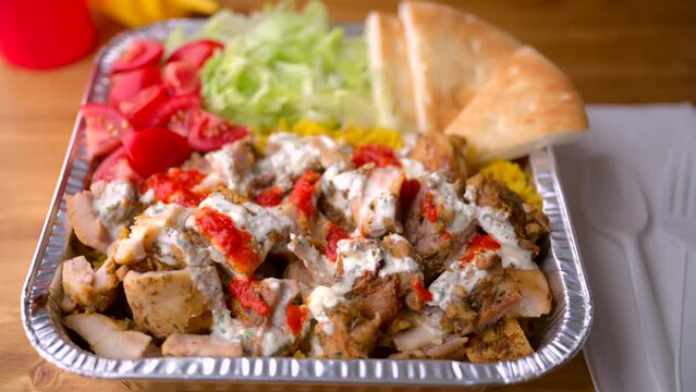chicken over rice in aluminum bowl, new york style famous halal food