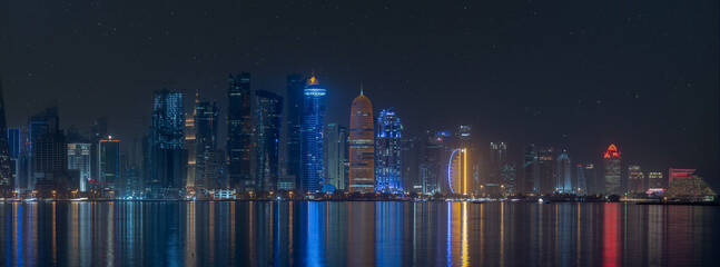 vibrant skyline of Doha city center during night.