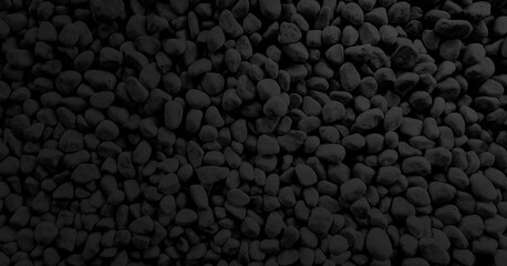 grunge dark black pebbles texture. small stones on the ground. top view of natural colorful gravel on japanese zen garden. black rock background texture .