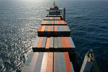 Feeder container ship at anchor near port Kingston during perfect weather and calm sea. View from forward © Maritime Art Blog