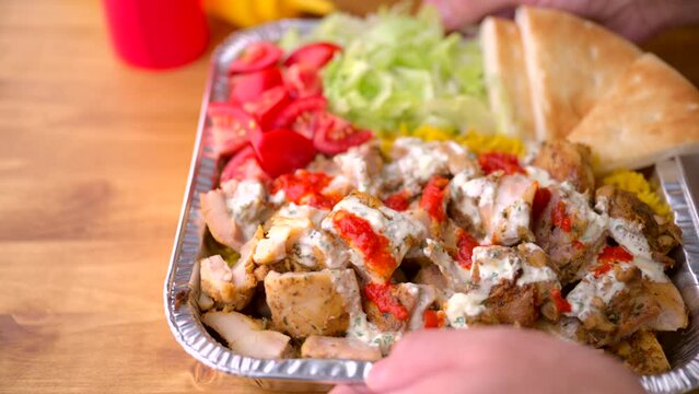 chicken over rice in aluminum bowl, new york style famous halal food
