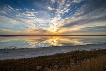 Scenic view of Chaplin Lake during sunrise reflecting on the water surface in Saskatchewan,Canada