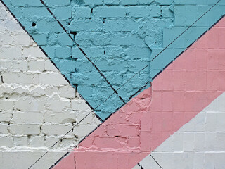Colorful painted brick and tile wall (white, blue, pink) as background or texture