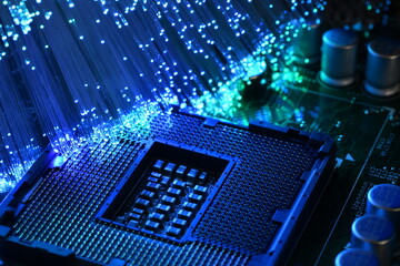 Detail of Socket of CPU on a PC Motherboard illuminated by a bunch of colored fiber optics....