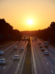 Sundown over motorway at rush-hour