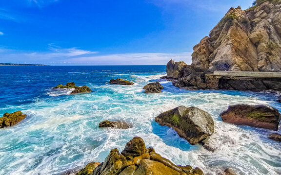 Beautiful surfer waves rocks cliffs at beach Puerto Escondido Mexico. © arkadijschell