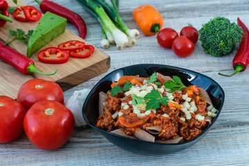 Italian spaghetti with ingredients on a wooden table