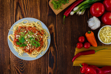 Italian spaghetti with ingredients on a wooden table