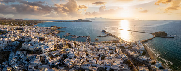 Aerial landscape panorama of the city with the old castle and port of Naxos island, Cyclades, Greece, during a beautiful summer sunset - obrazy, fototapety, plakaty