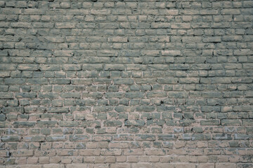 Spacious old abandoned brickwall background with aging surface. Vintage design wallpaper.