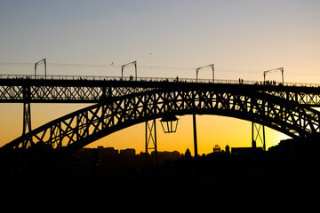 Sunset at the landmark of Ponte Luis I bridge in Porto Portugal during the busy summer months