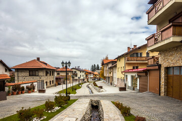 Gotse Delchev street in Bansko, a kempt pedestrian street in city center. Small bulgarian town in the autumn cloudy day.