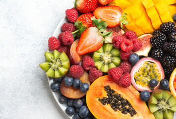 Delicious fruits on white background, mango pomegranate raspberries papaya oranges passion fruits...