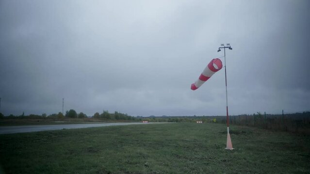 A wind flag in cloudy weather on the runway. High quality FullHD footage