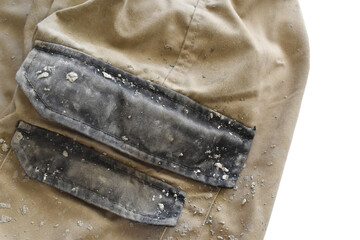 Dirty clothes with cement stains.  Photo can be used for the concept of how to remove cement stains on clothes or fabric. 