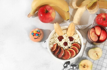 Fototapeta na wymiar Healthy breakfast with ingredients, fun food for kids. Cottage cheese with figs and bananas, apples and grapes, top view, Healthy and natural food concept.