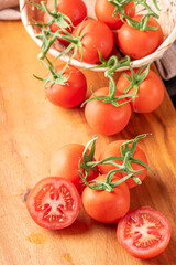 Tomatoes, beautiful details of fresh red tomatoes on branches over rustic wood, selective focus.