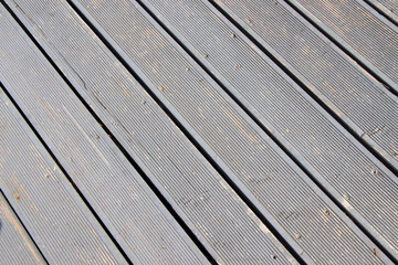 The floor is made of light-colored plastic composite terrace boards.