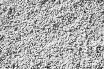 Natural white granite chips, crushed stone. View from above. Background. Texture.