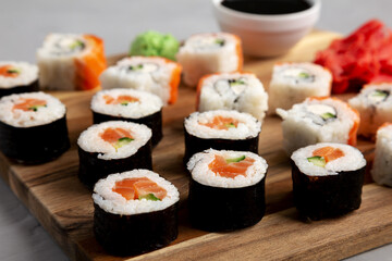 Homemade Sushi Platter with Wasabi and Soy Sauce on a Board, side view.
