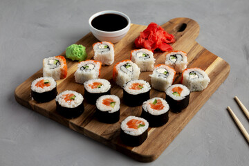Homemade Sushi Platter with Wasabi and Soy Sauce on a Board, side view.
