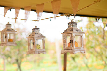 Decorative candle lantern hanging in the garden. Halloween decor party