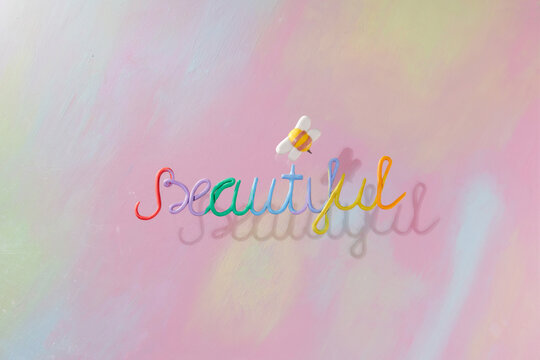 On a colorful background, the word "beautiful" and around it
