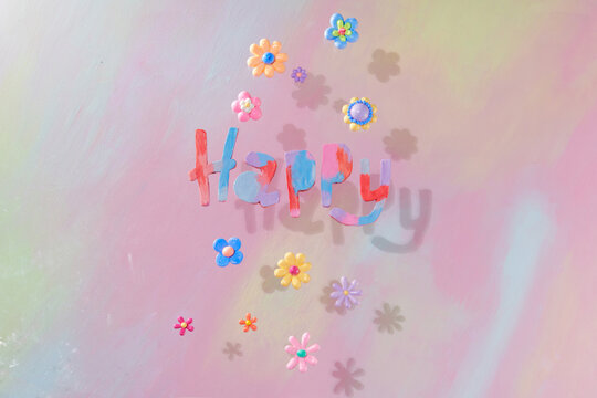 Happy wording is decorated with multiple colors clay