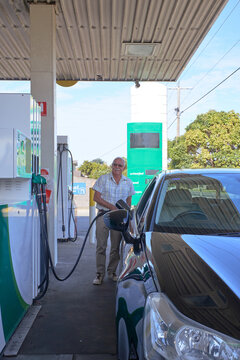 Senior man at gas station refuelling car