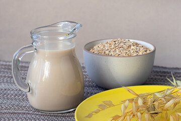 Healthy food concept, oat milk, oatmeal and oat ears. Vegetarian and vegan product, lactose-free milk