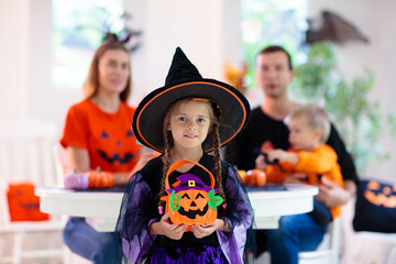 Family carving pumpkin. Halloween trick or treat
