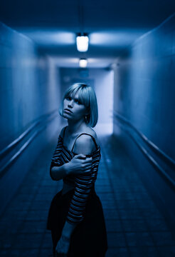 blond young woman at night
