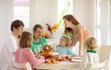 Obraz na płótnie Canvas Family with kids at Thanksgiving dinner. Turkey.