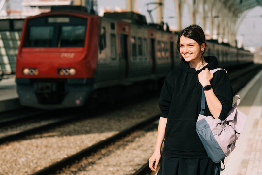 Smiling student waiting for train