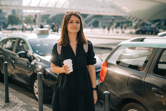 Woman with coffee to go on the street