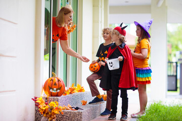 Kids trick or treat. Halloween. Child at door.