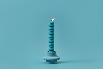 Burning handmade candle with cell pattern.