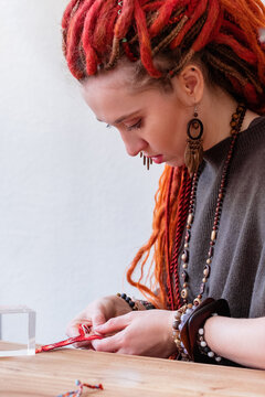 Female artisan creating friendship bracelet