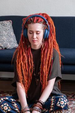 Female hippie listening to music on floor