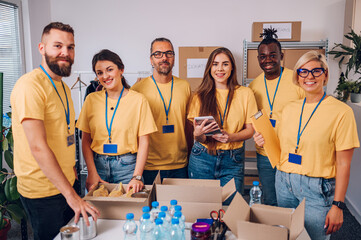 Group of multiracial volunteers working in community charity donation center