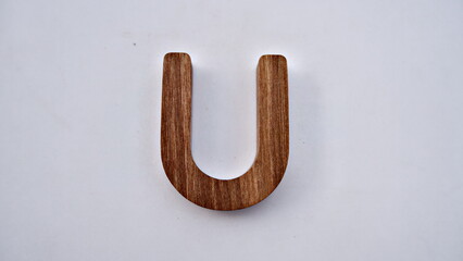 Wooden textured alphabet letters on a white background , selected focus isolated photo