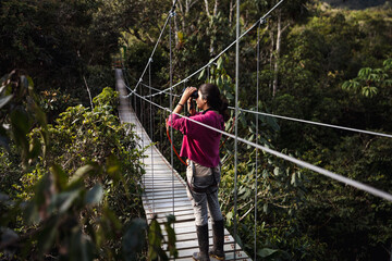 Woman Walking Through A Hanging Bridge