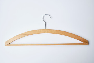 White clothes hanger on a light background. Smart consumption or sales concept