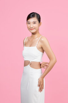 Beautiful woman model posing in white dress in the studio