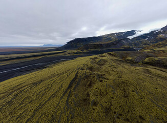 Aerial shot, Nice landscape of mountains and rivers with mossy field in iceland