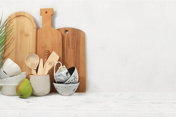 Fototapeta na wymiar Kitchen table with utensils and cutting boards.Simple home kitchen interior, mockup for product design and display, zero waste and healthy lifestyle concept, selective focus