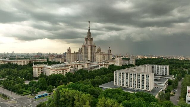 The main building of Moscow State University against the background of a cloudy stormy sky. The famous Stalin high-rise, a monument of Soviet architecture against the background of the modern city.