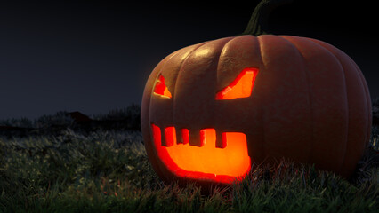Cut pumpkin lamp on the field of grass at night